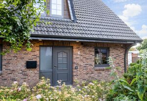 Dünen Lodge – Moderne Erdgeschosswohnung mit großzügiger Terrasse und eigenem Garten