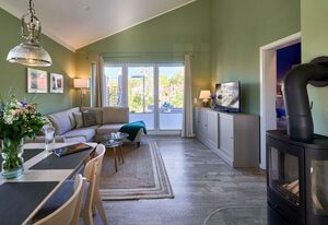 Feriendorf Südstrand – Sonne, Strand & Sauna – Lütt Strandhuus Pelzerhaken mit Kamin und Garten